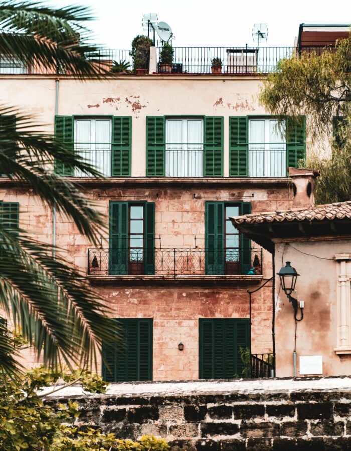 Vertical shot of a residential building with windows and balconies A vertical shot of a residential building with windows and balconies